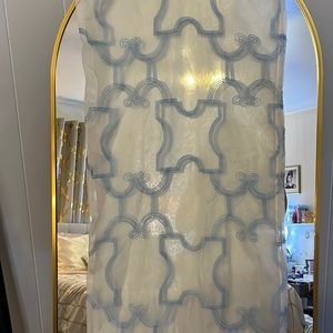 Sheer white curtain with light blue embroidery. Floor length.